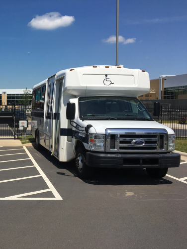 Two mts buses parked in a parking lot on a sunny day.